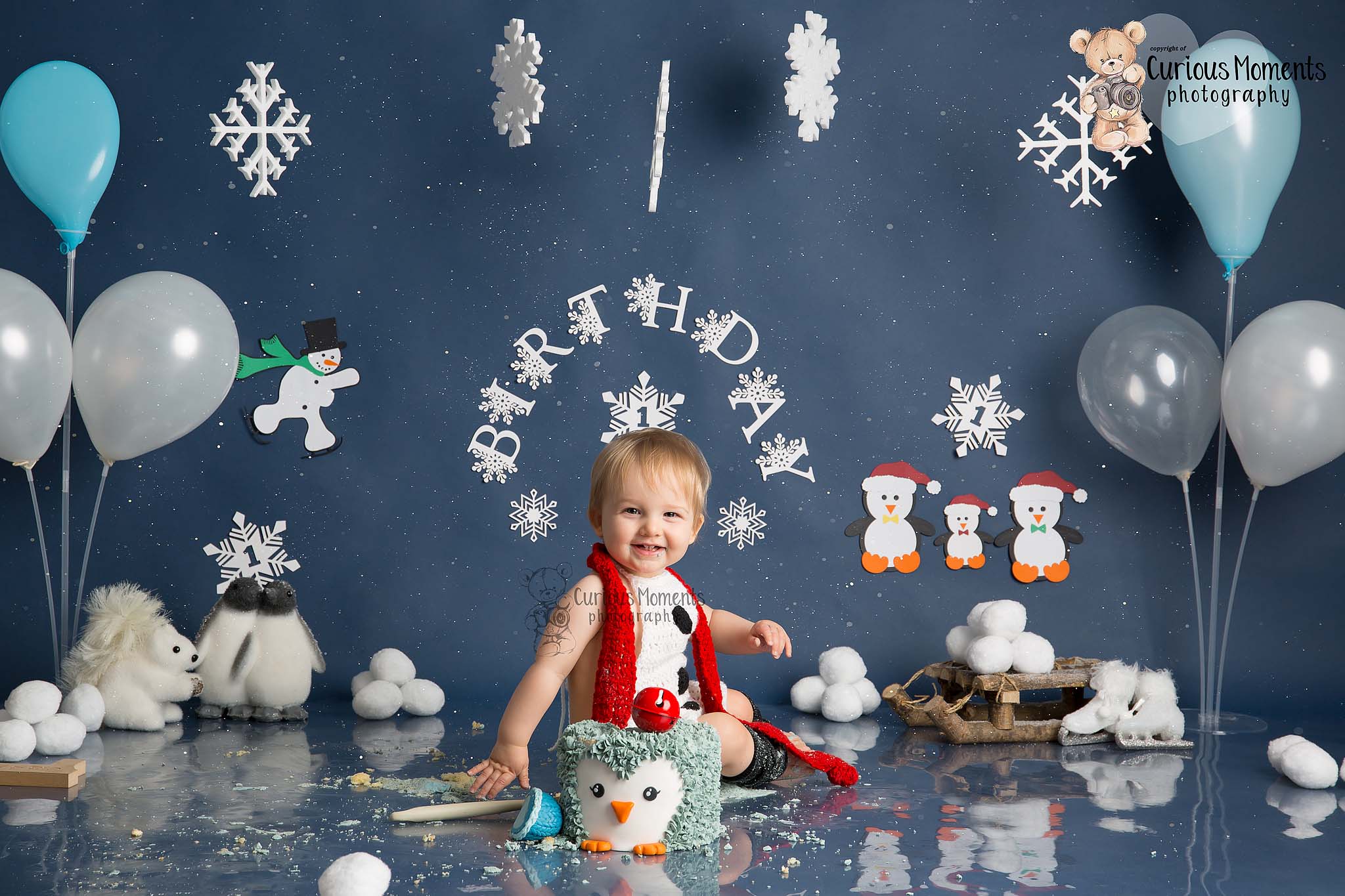 Winter wonderland cake smash for baby boy with snowmen, penguins and snowflakes