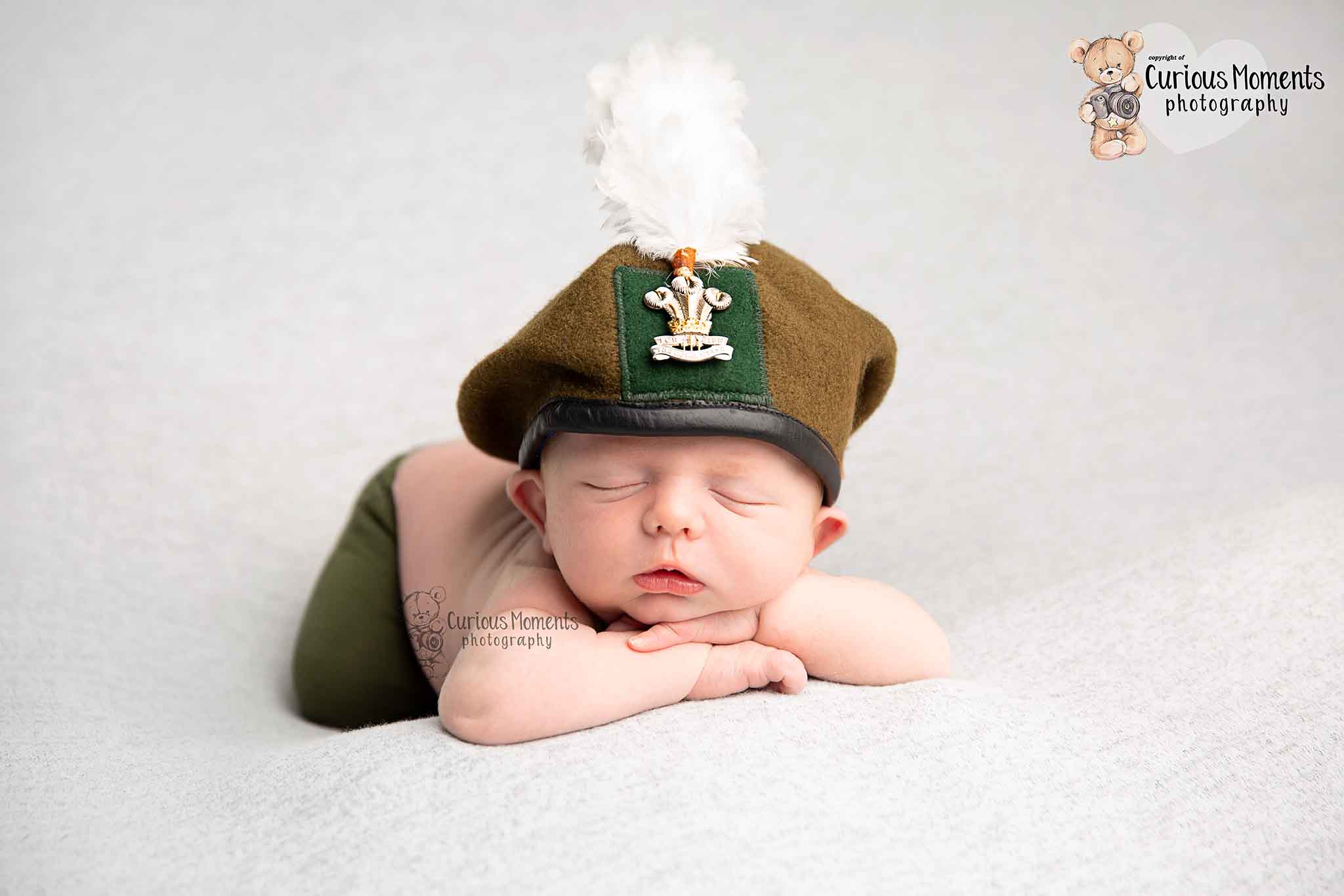 newborn baby wearing dads army hat